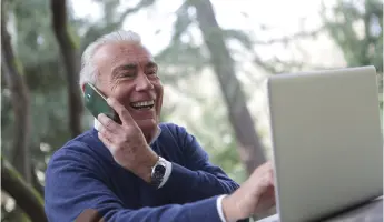 Smiling retiree talking on the phone